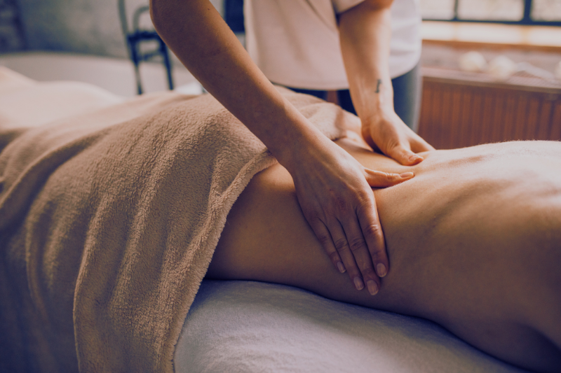 a lady laying on the massage bed enjoying a Swedish massage at healspa centre